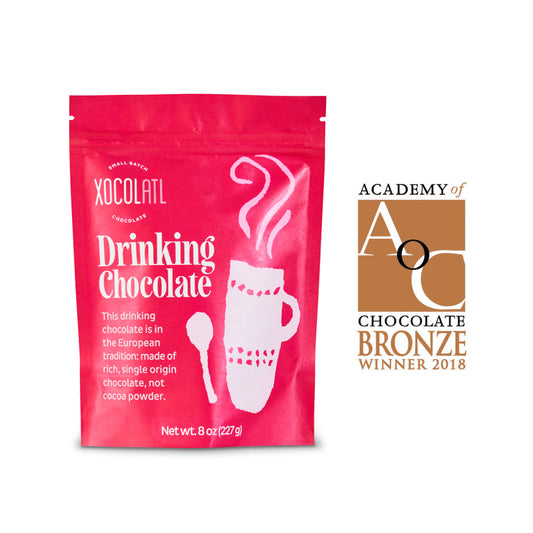 Pink package of Xocolatl drinking chocolate with a bronze award logo on a white background