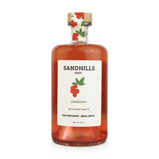 Bottle of Sandhills Elixir Cranberry with a white label on a white background